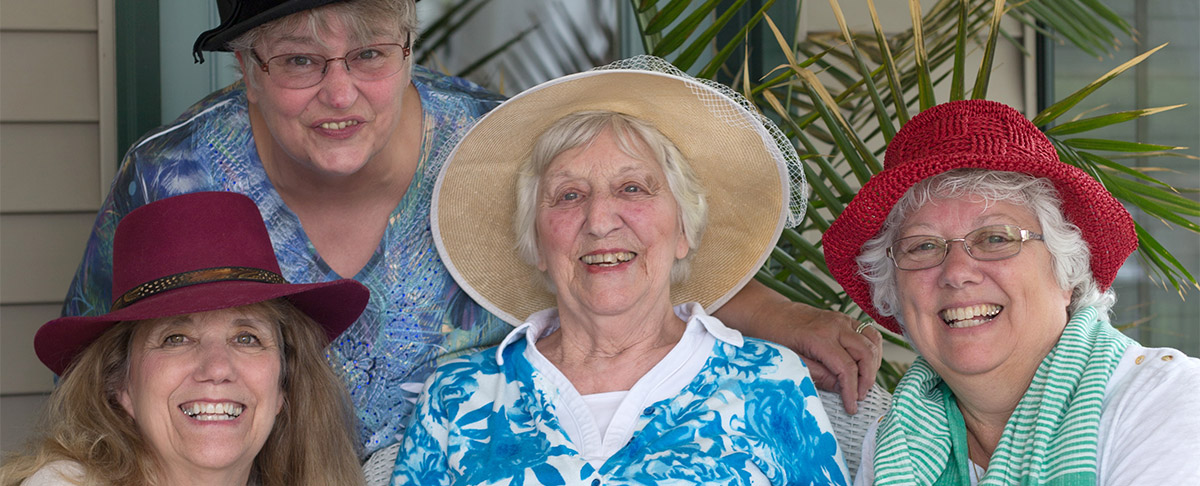 4 women smiling outside